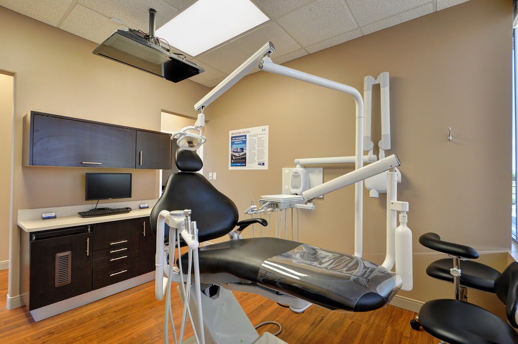 A clean, modern dental office counter displaying a variety of oral hygiene tools like electric and manual toothbrushes, floss, and mouthwash, highlighting proactive dental care.